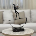 Balancing Man With Steel Sphere